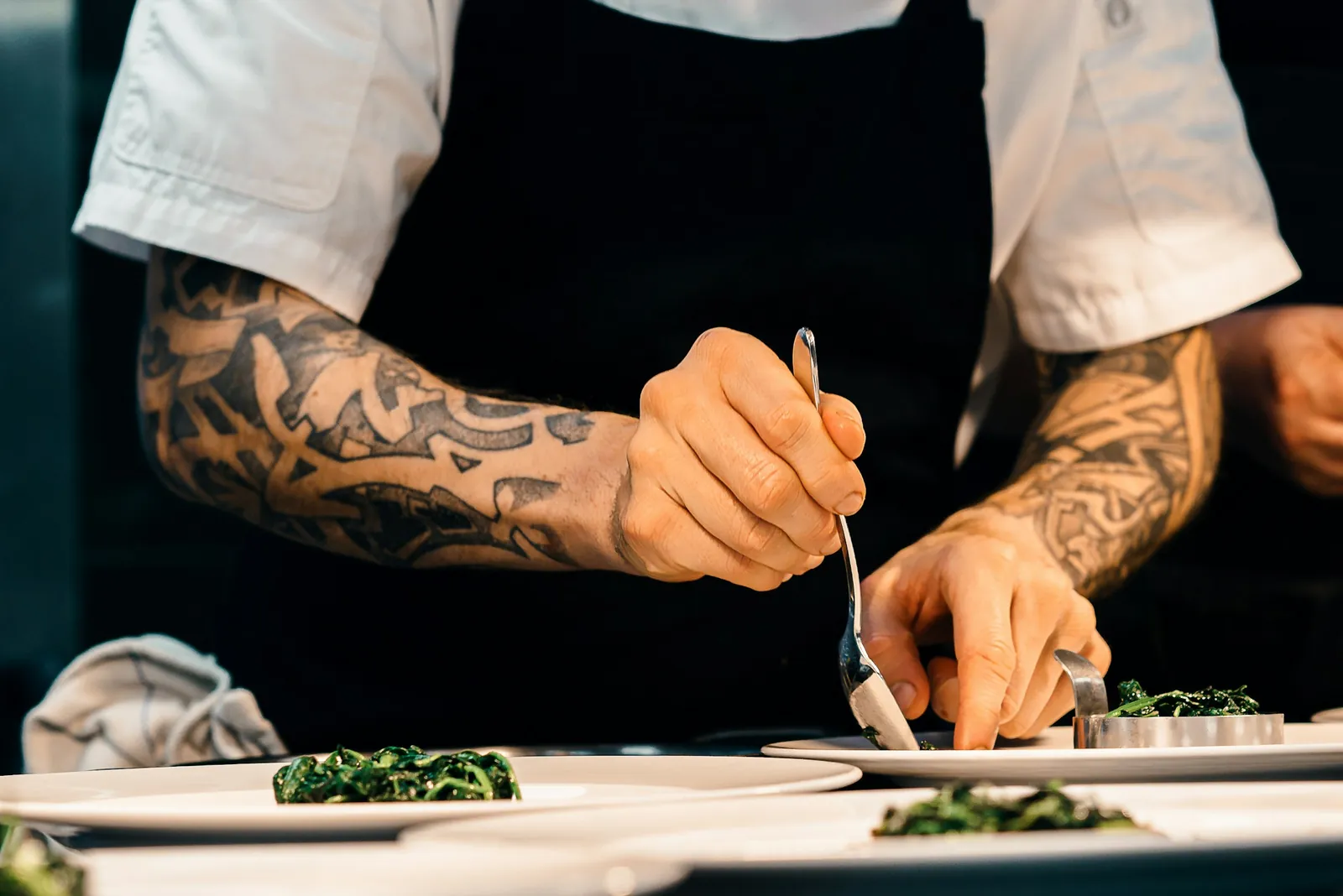 Hands adding the finishing touch to a plate