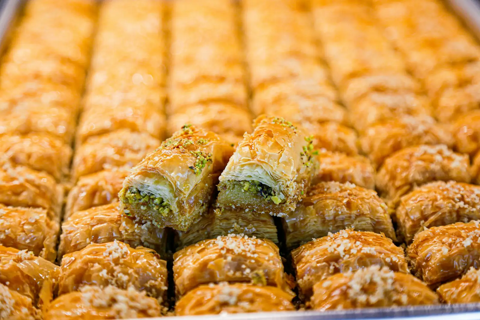 Pistachio baklava lined up on a tray