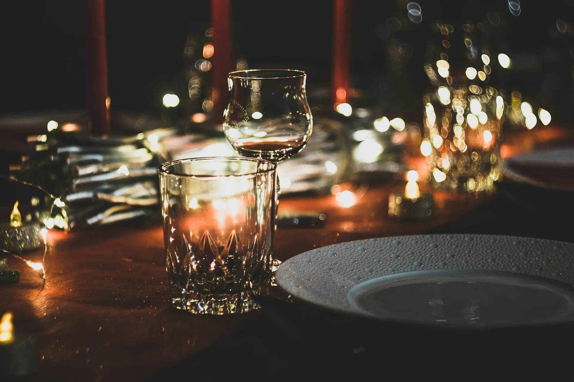 Crystal glass and plate on a candlelit table